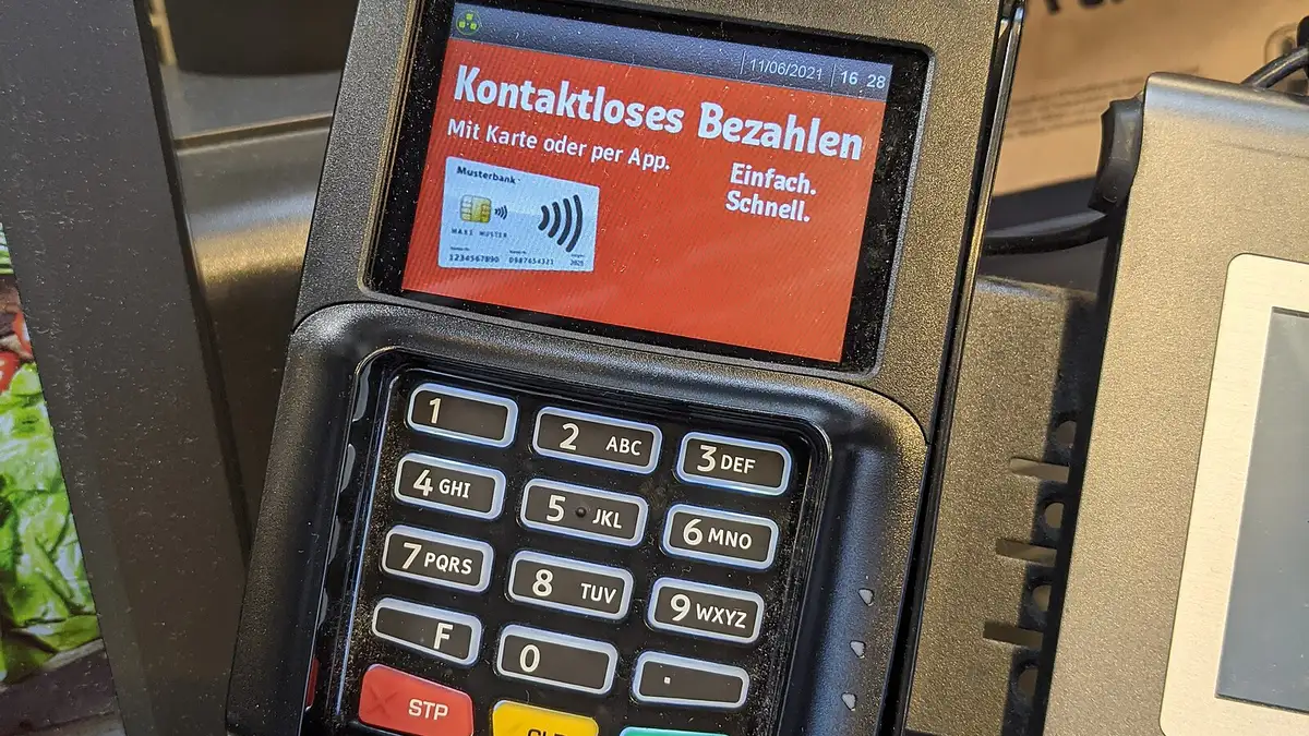 A payment terminal attached to a self-checkout machine in a supermarket